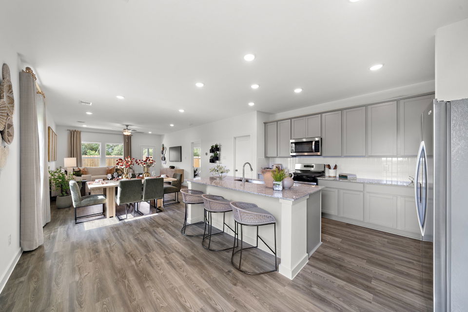 A kitchen with a wood floor.