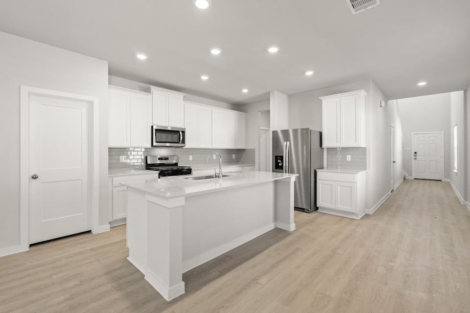 A kitchen with white cabinets.