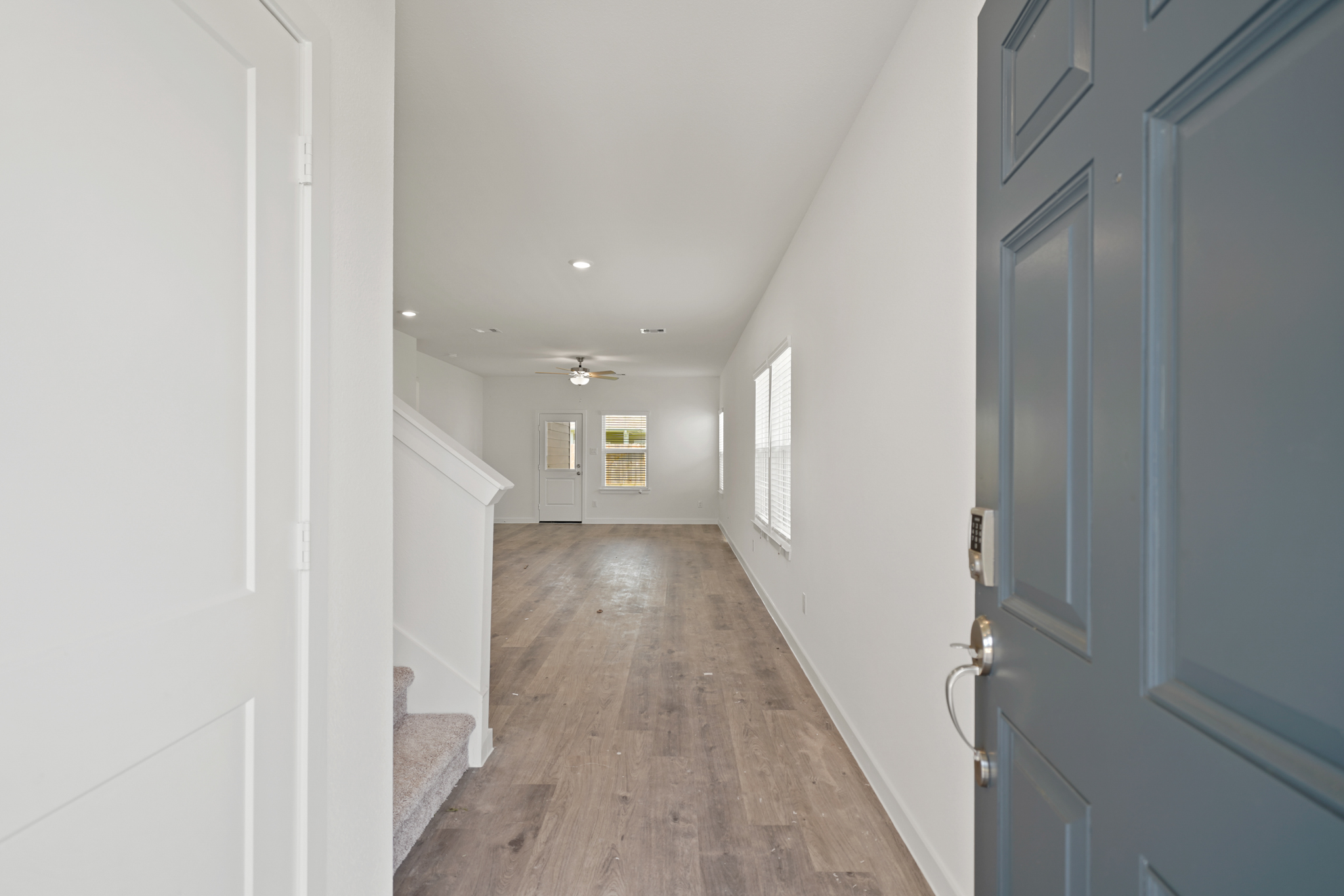 A hallway with white walls.