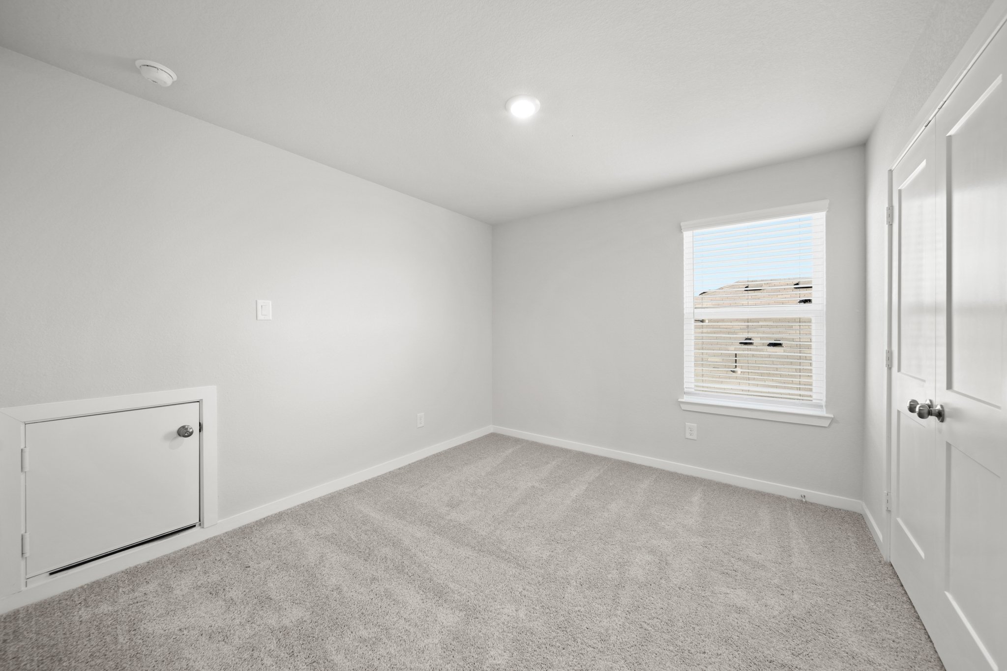 A room with white walls and a white door.