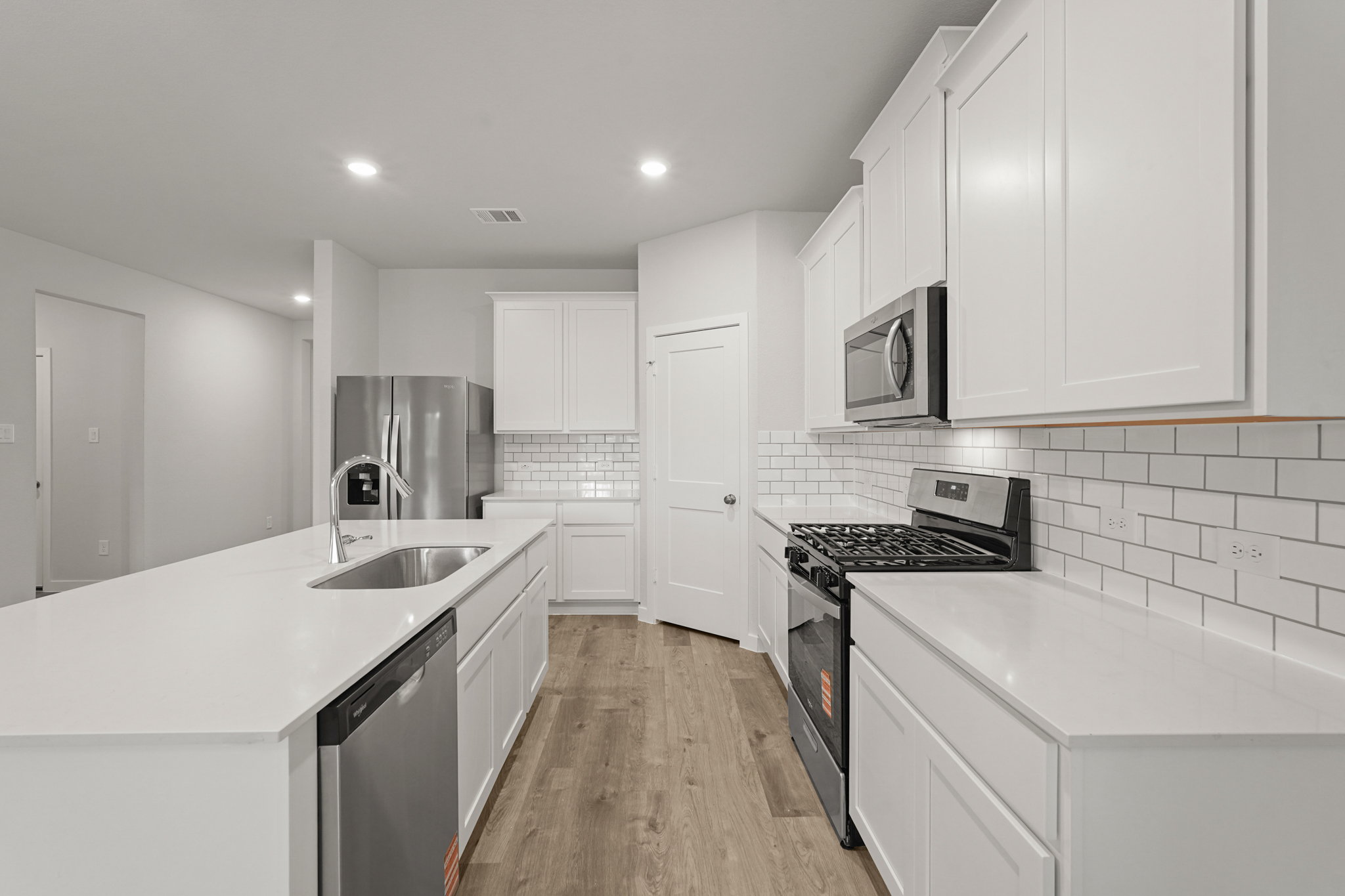 A kitchen with white cabinets.
