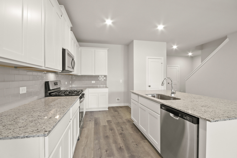 A kitchen with white cabinets.