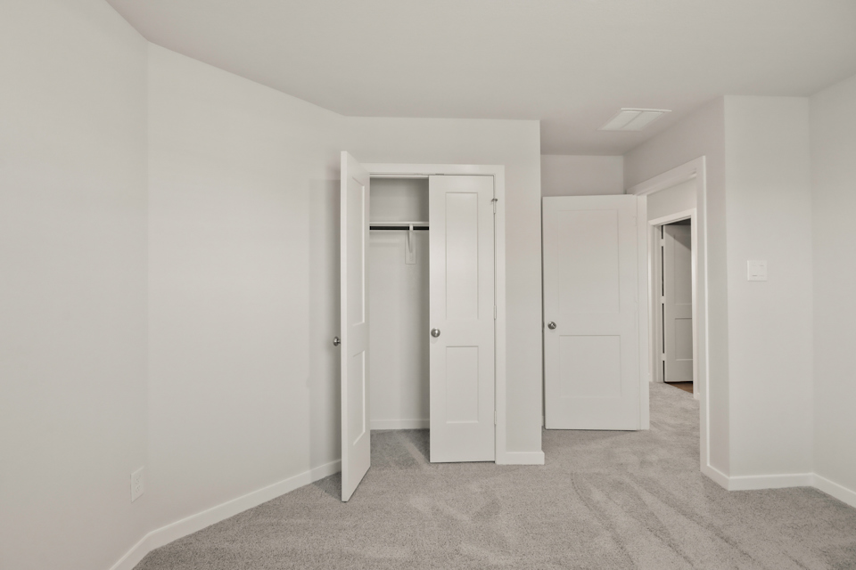 A hallway with white doors.