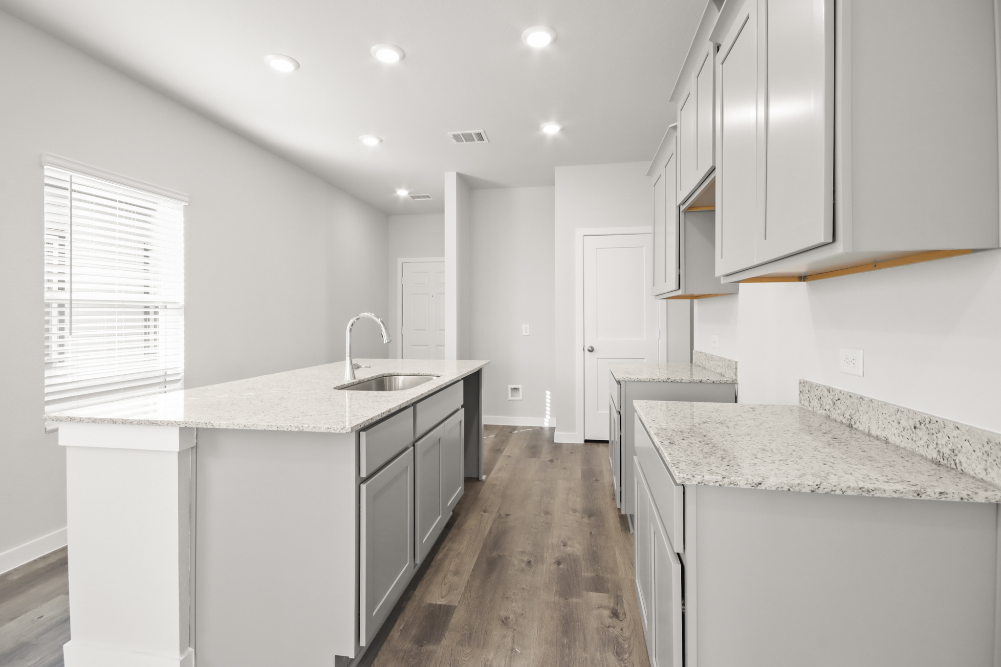 A kitchen with white cabinets.