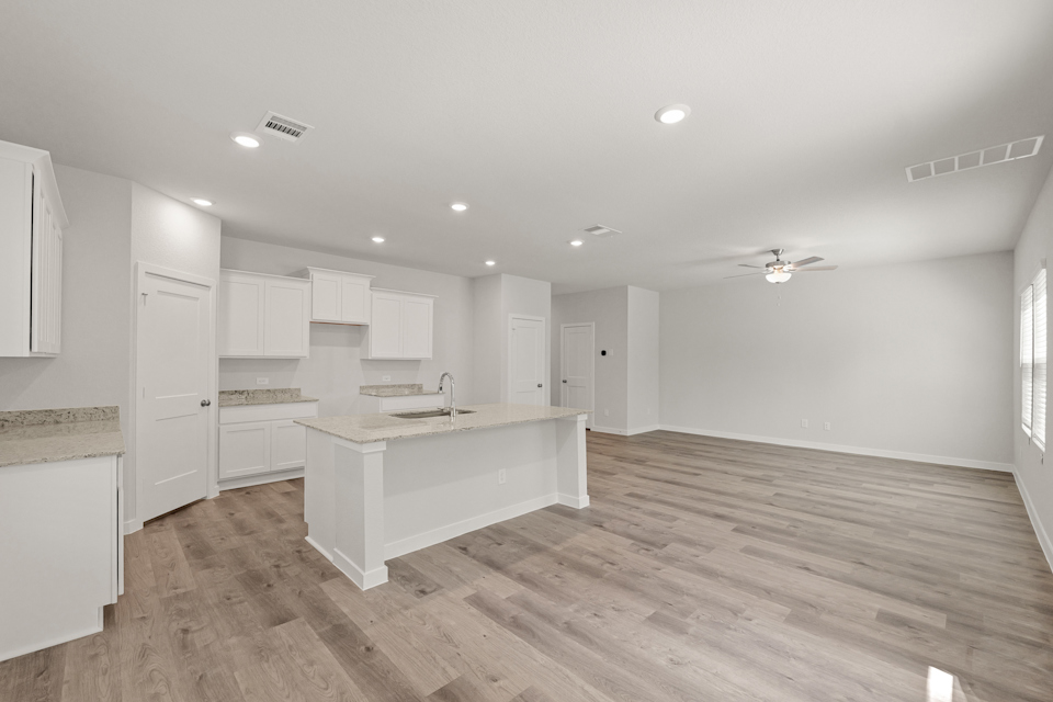 A kitchen with white cabinets.