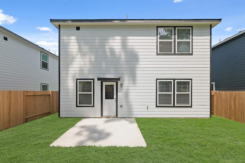 A grey house with a white door.
