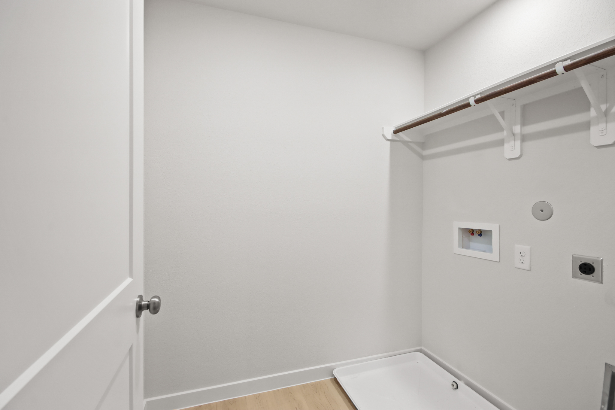 A white bathroom with a white door.
