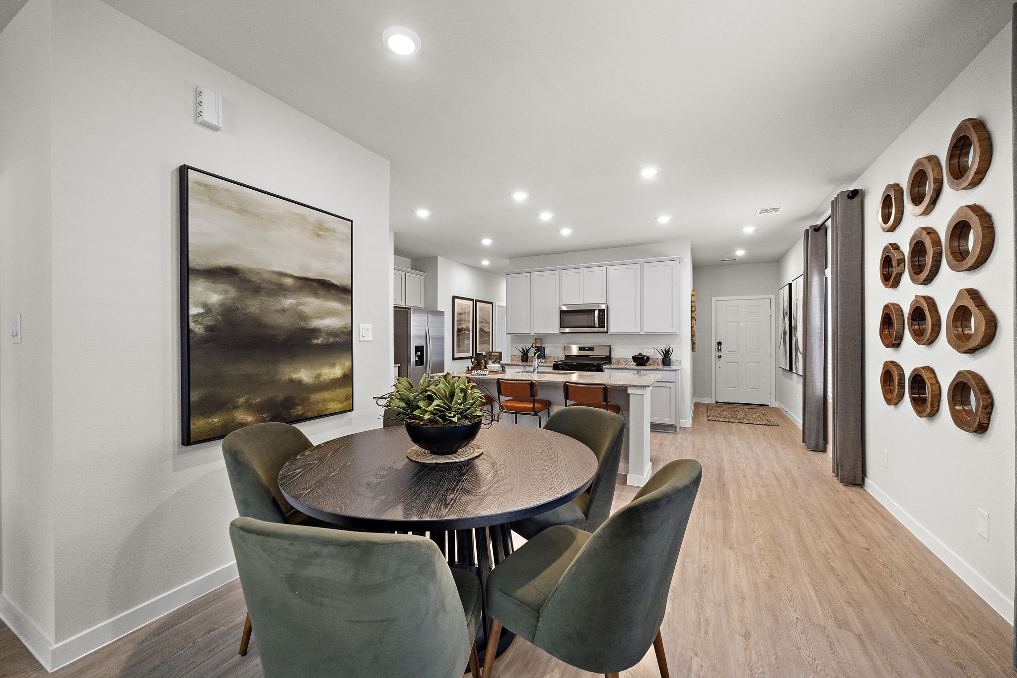 A large kitchen with a dining table.