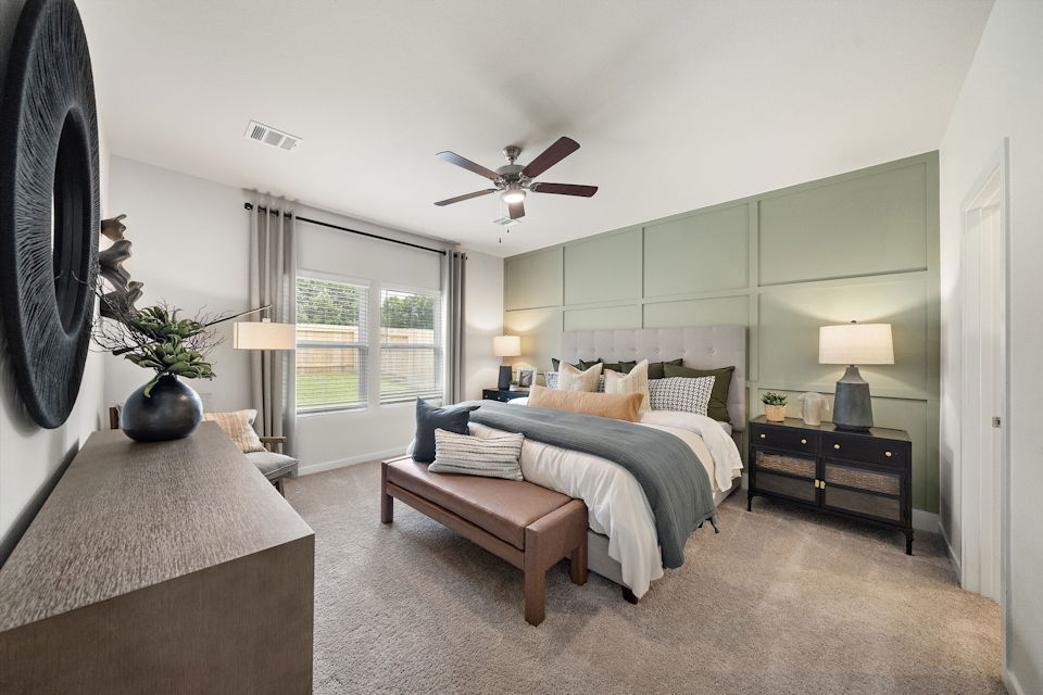 A bedroom with a bed and a bench.