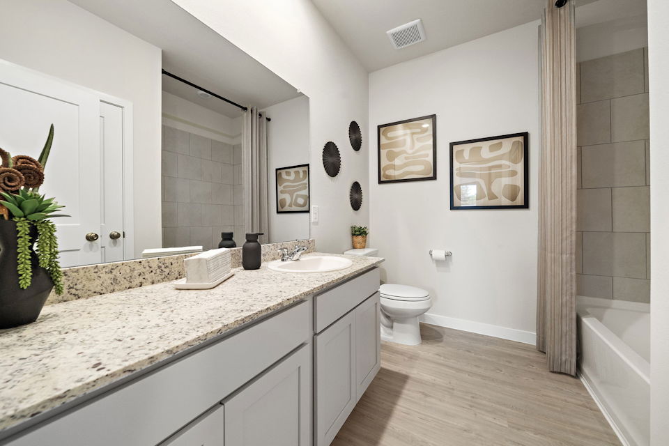 A bathroom with a marble countertop.