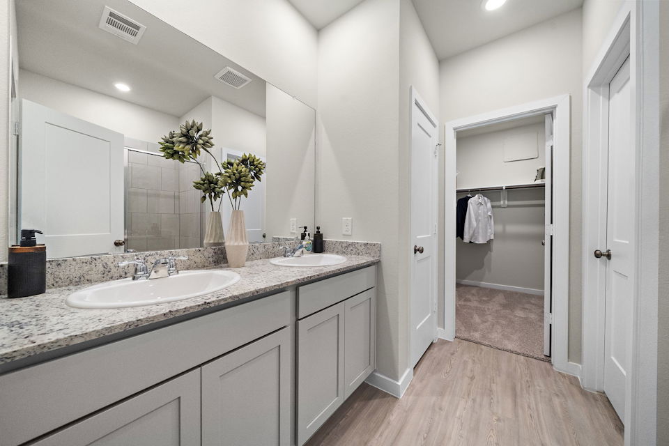 A bathroom with a large mirror.
