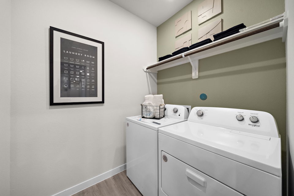 A white kitchen with a shelf.