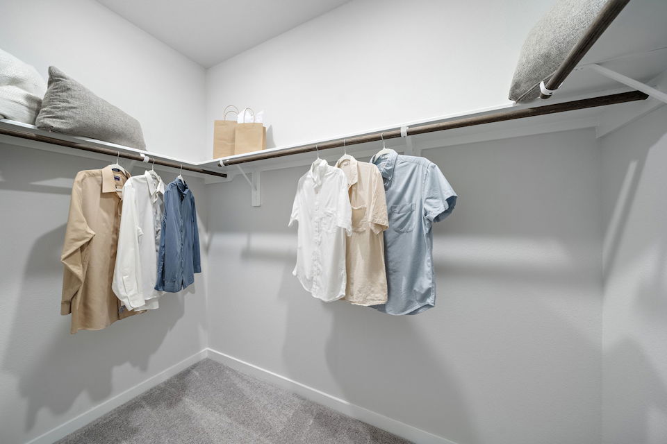 A row of towels on a rack in a bathroom.
