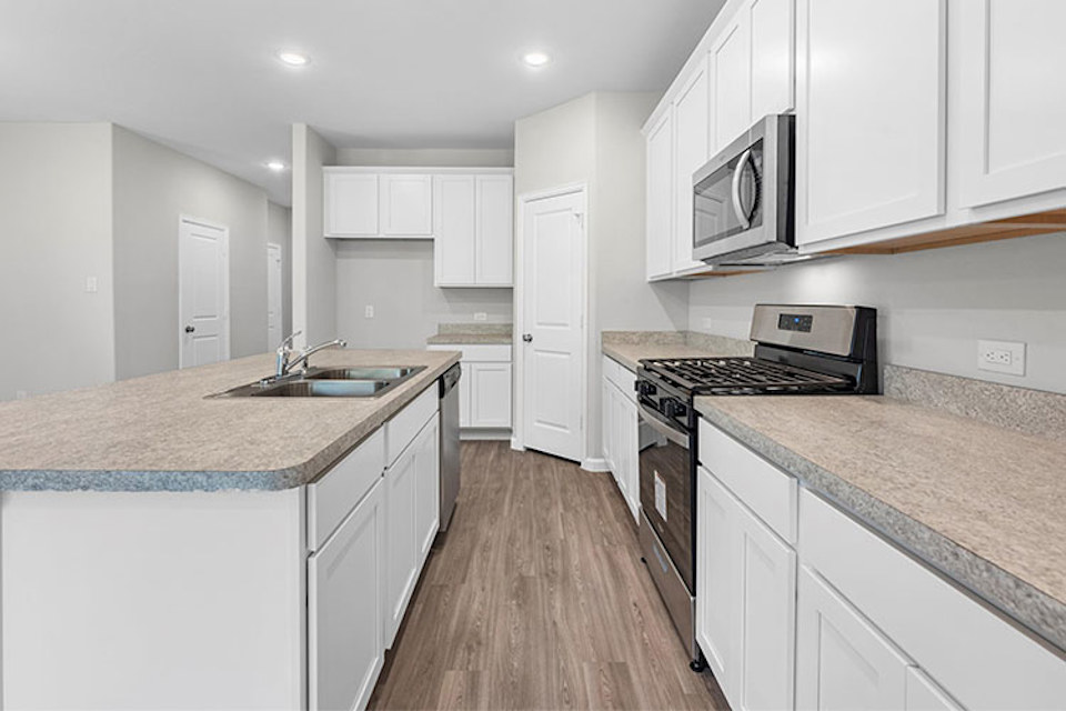 A kitchen with white cabinets.