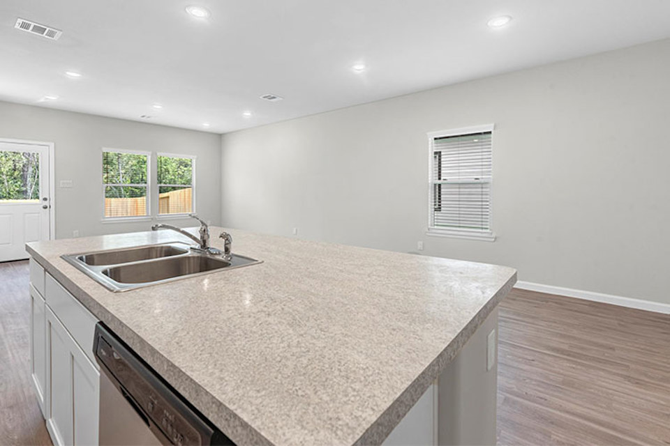 A kitchen with marble counters.