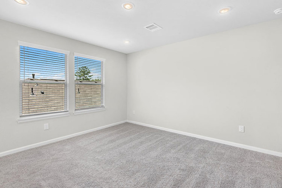 A room with a window and a carpet.