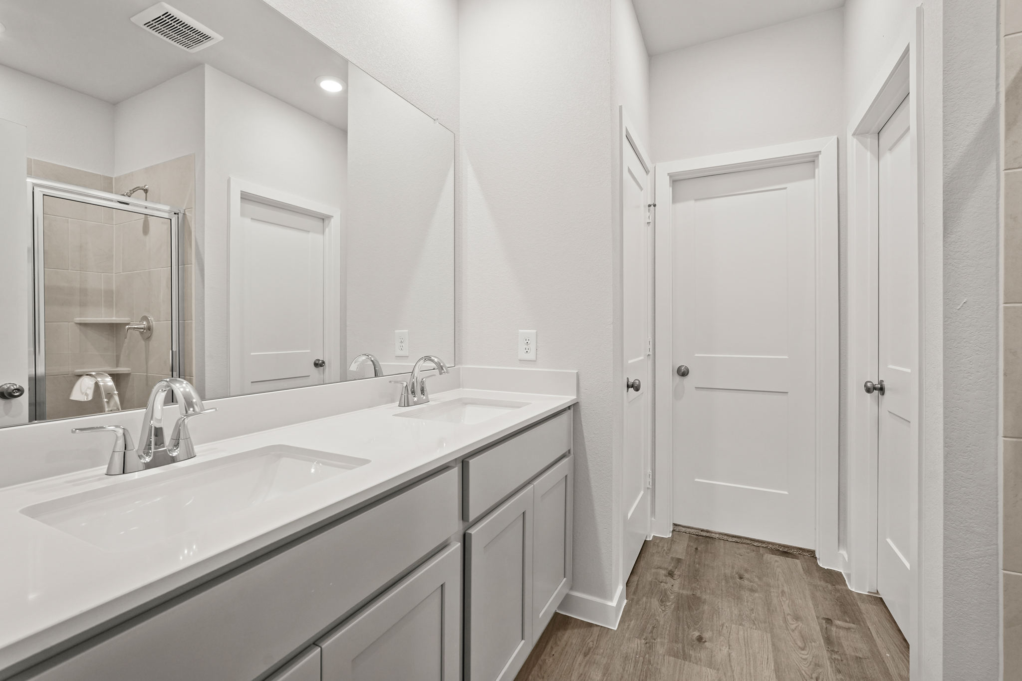A bathroom with a large mirror.