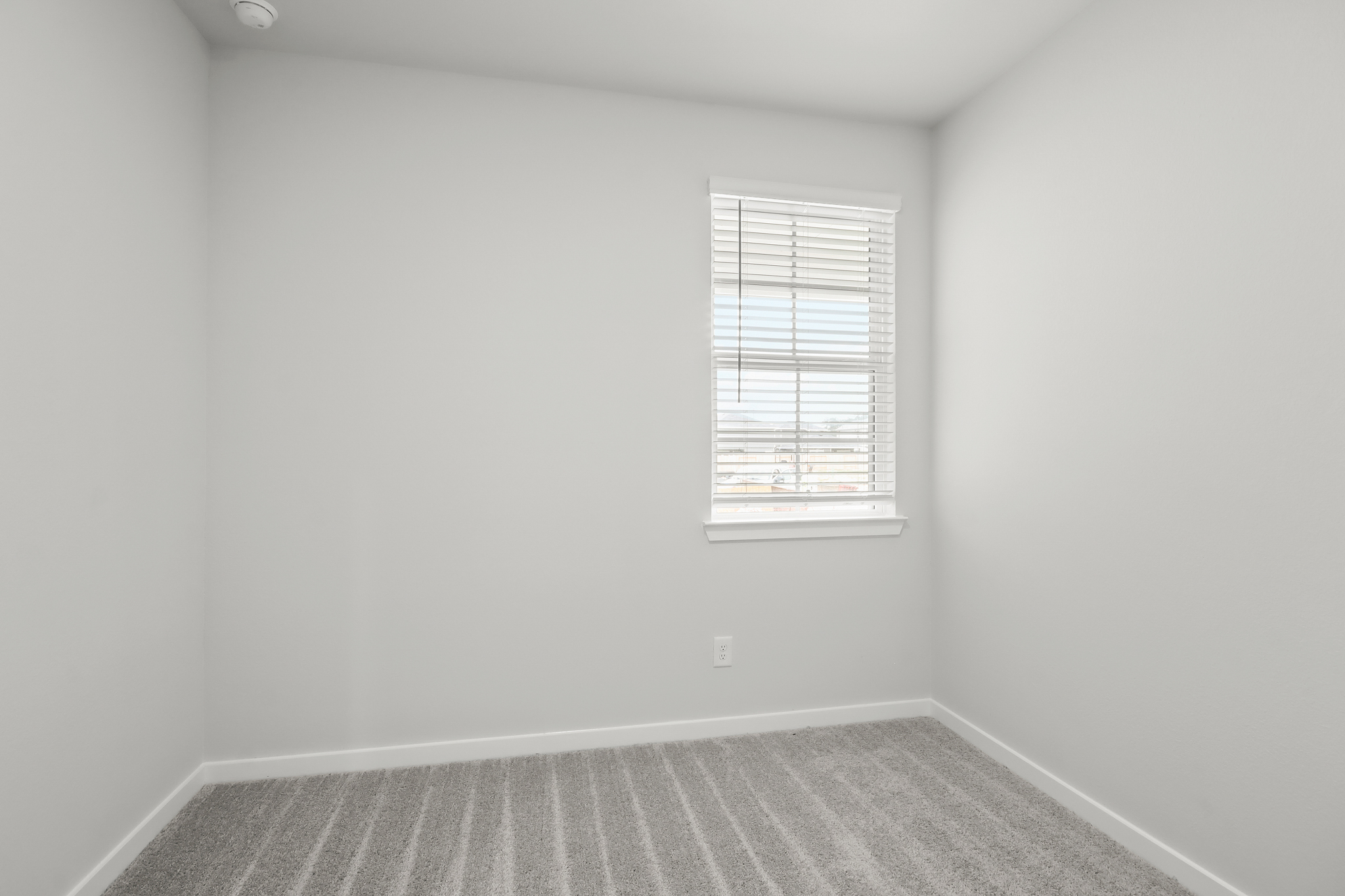 A room with a bed and a window.