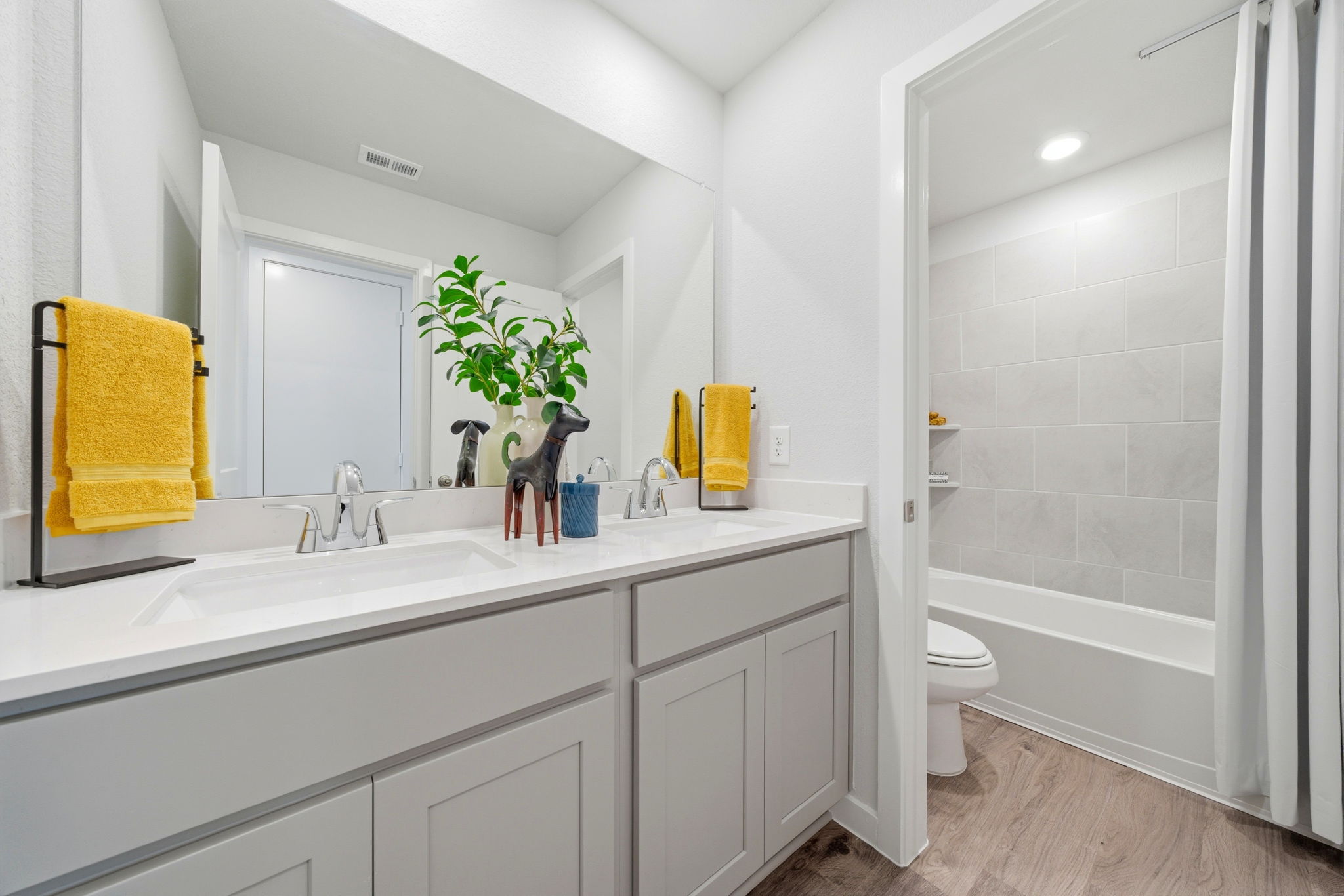 A bathroom with a tub sink and toilet.