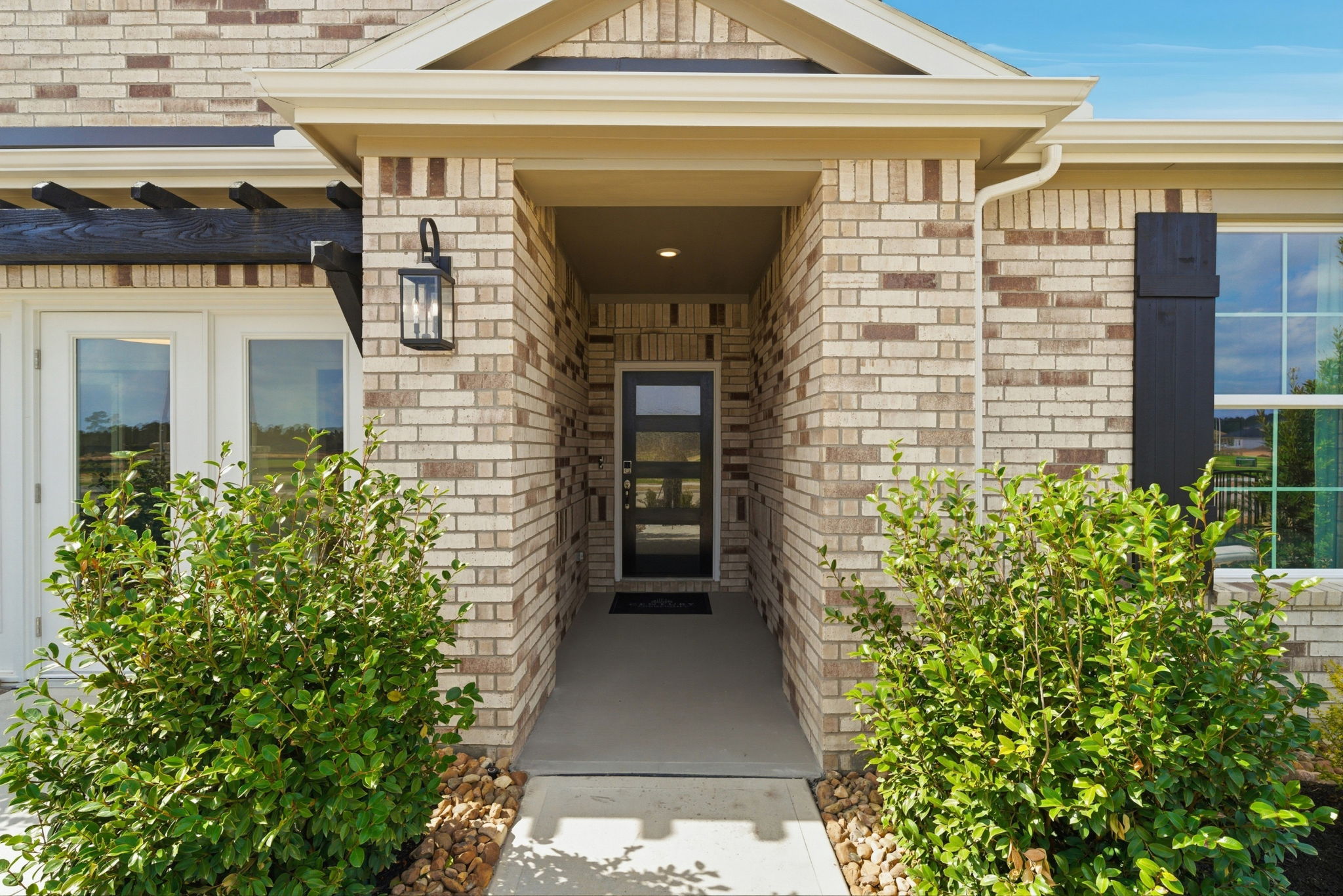 A brick building with a door and windows.