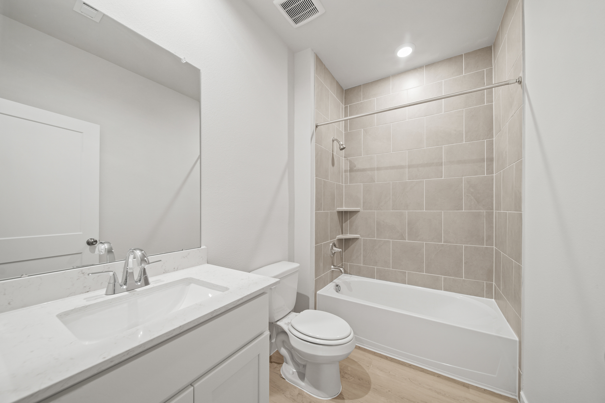 A bathroom with a tub sink and toilet.