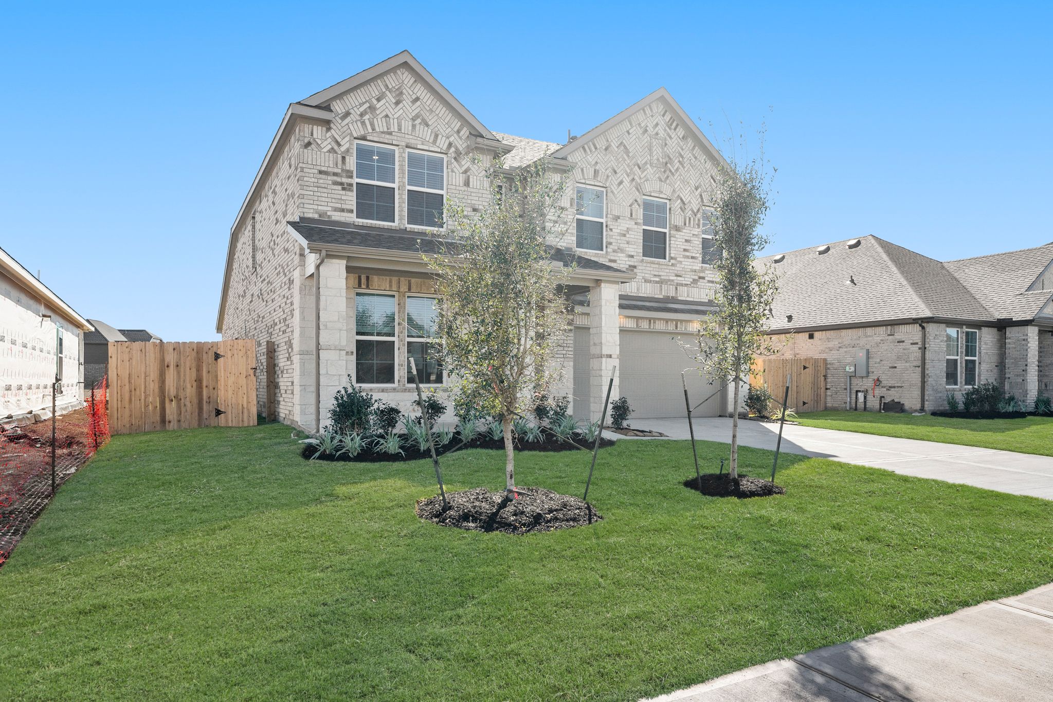 A large house with a lawn and trees in front of it.