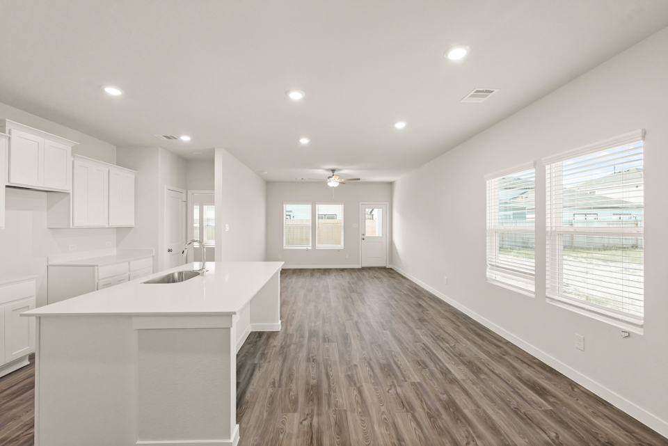 A kitchen with white cabinets.