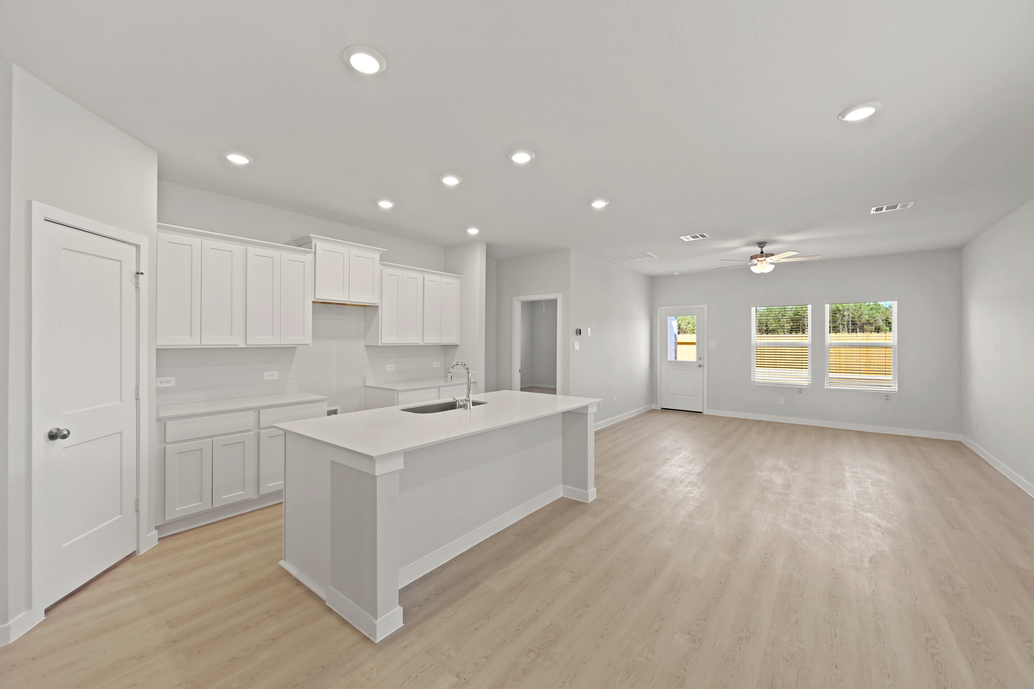 A kitchen with white cabinets.