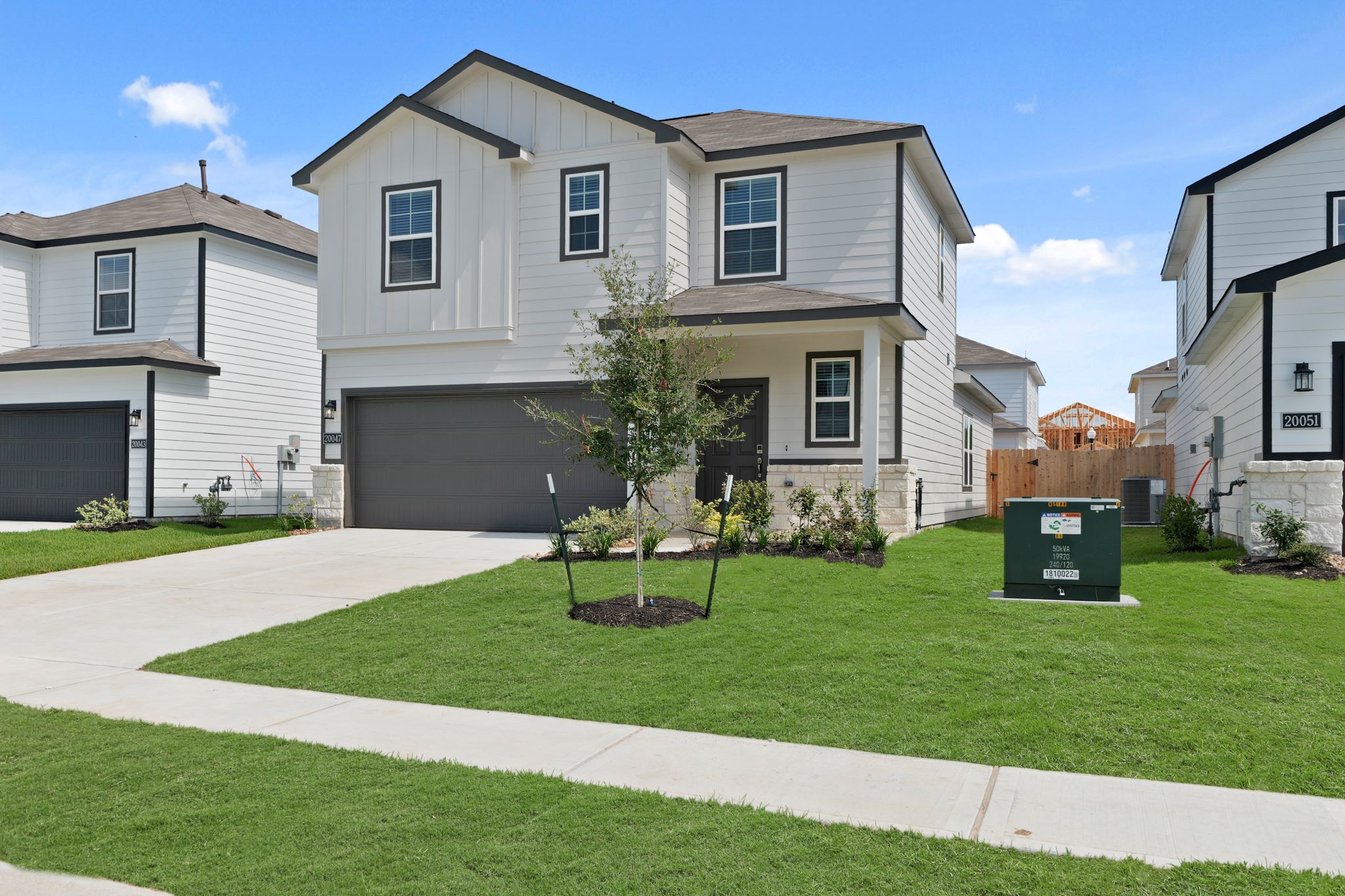 A house with a tree in the front.