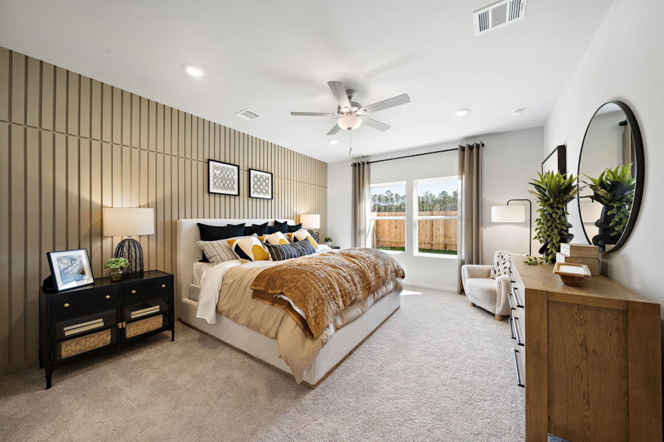 A bedroom with a large window.