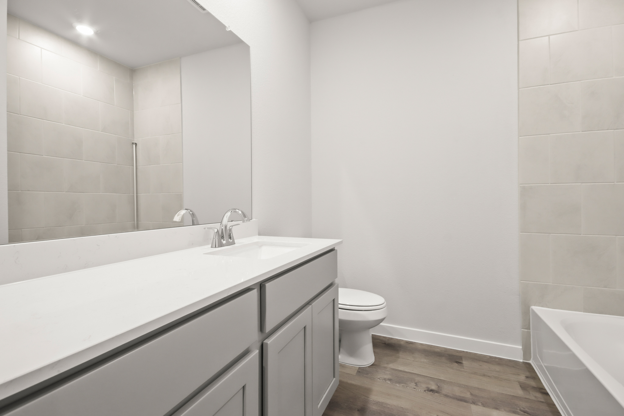 A bathroom with a tub toilet and sink.
