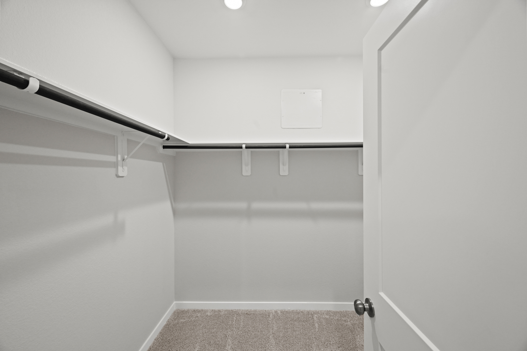 A white door with a metal bar.