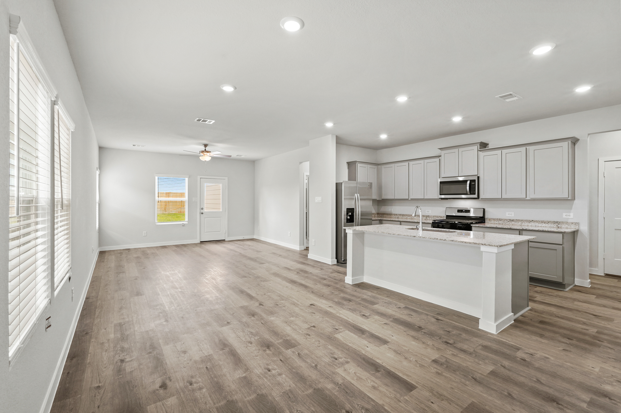 A kitchen with white cabinets.