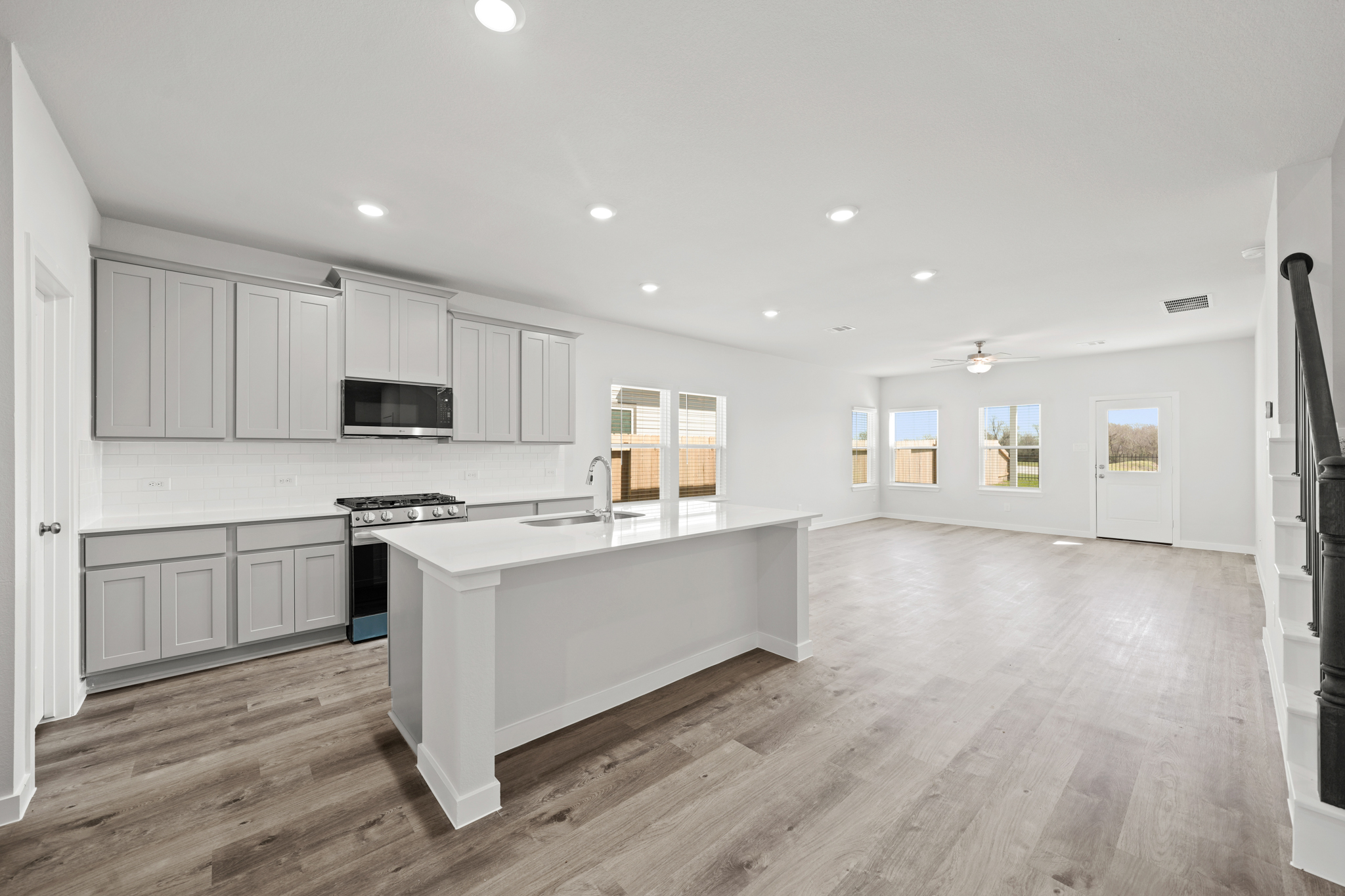 A kitchen with white cabinets.