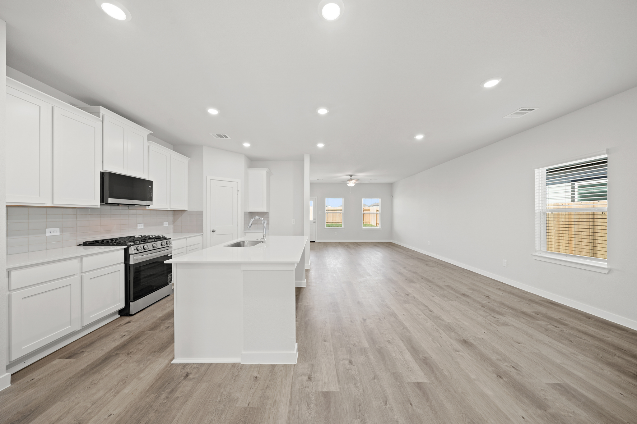 A kitchen with white cabinets.