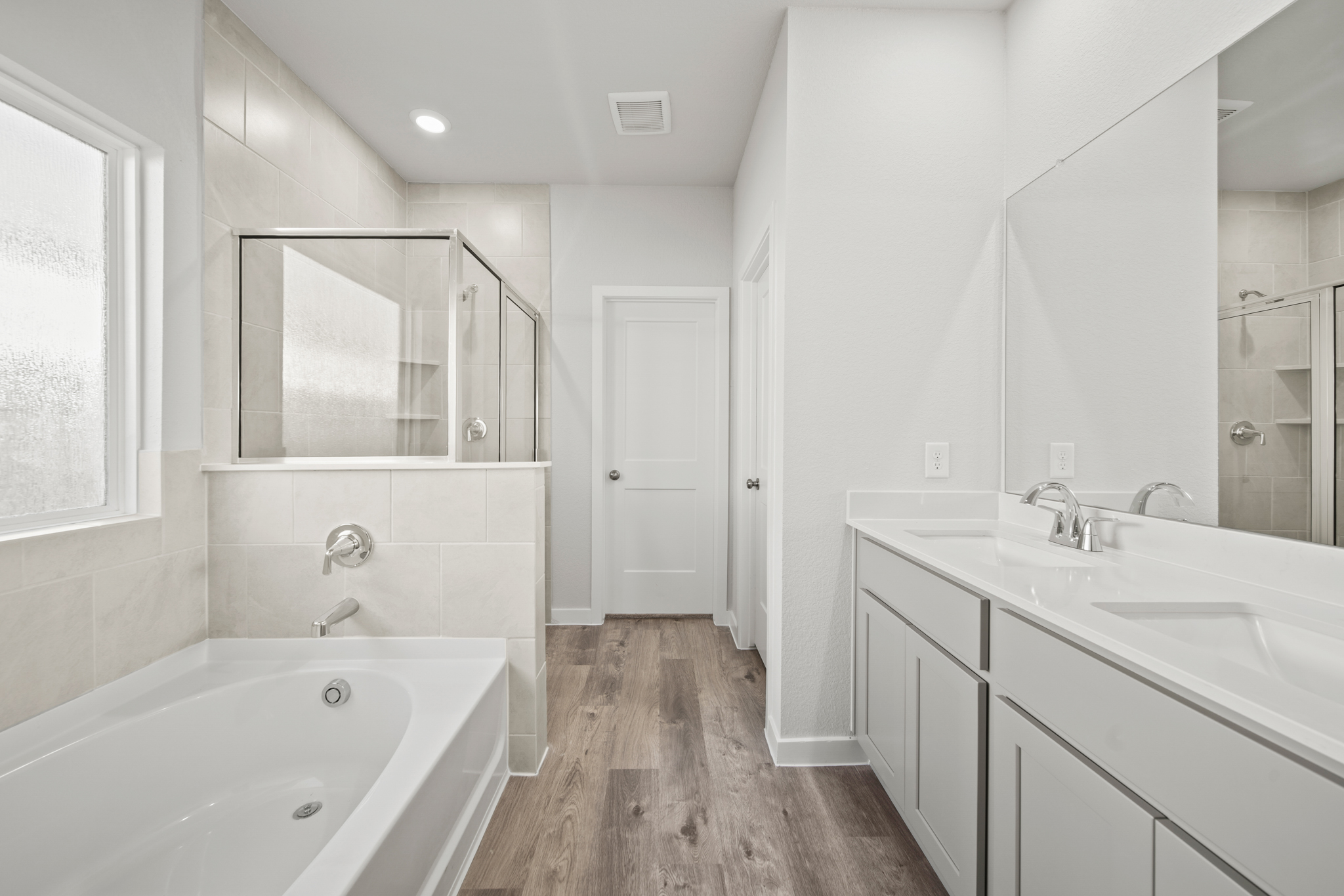 A bathroom with a tub and sink.