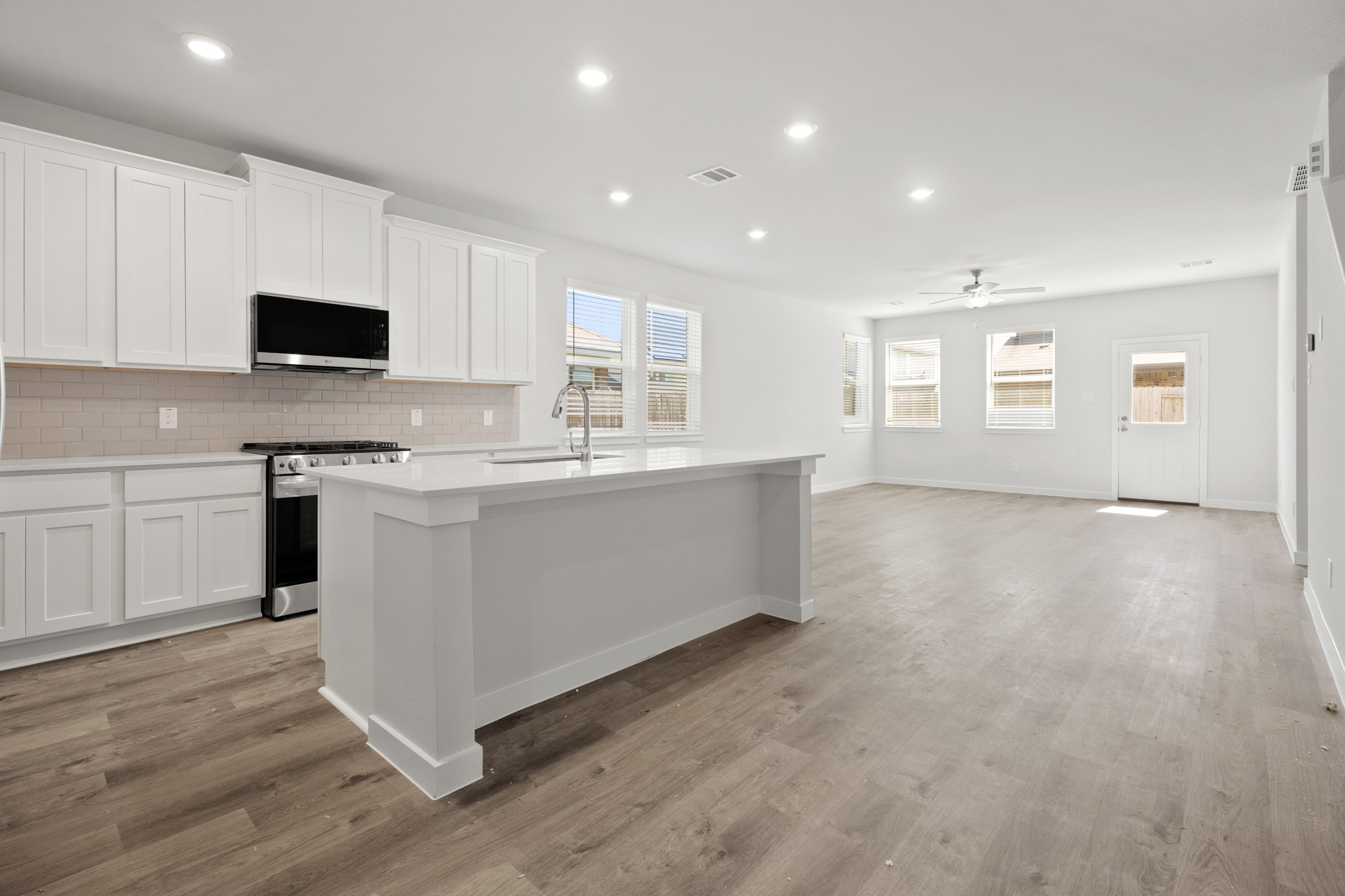 A kitchen with white cabinets.