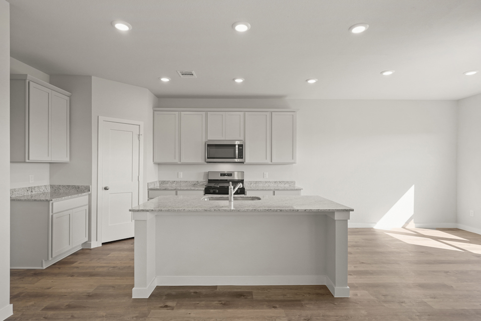 A kitchen with white cabinets.