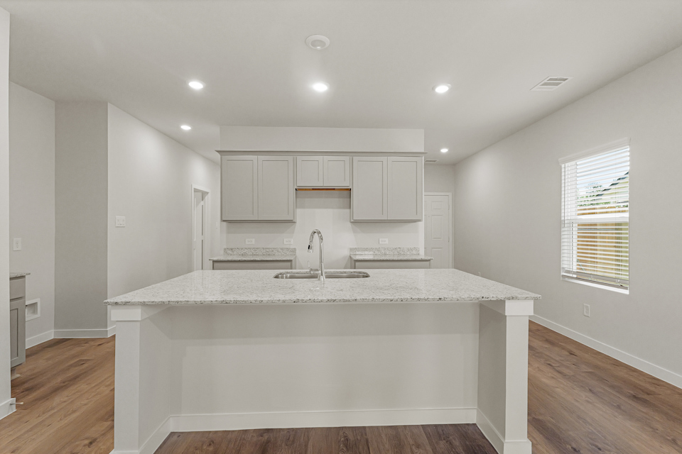 A kitchen with a marble countertop.