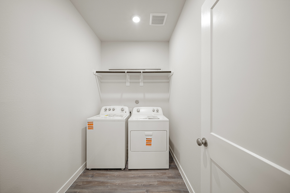 A washing machine in a room.