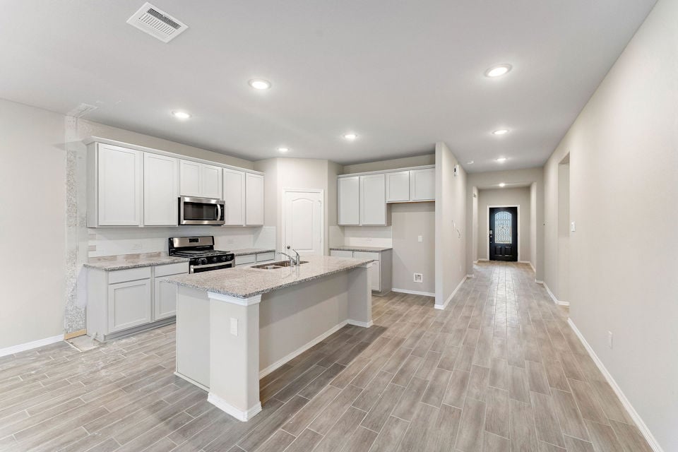 A kitchen with white cabinets.