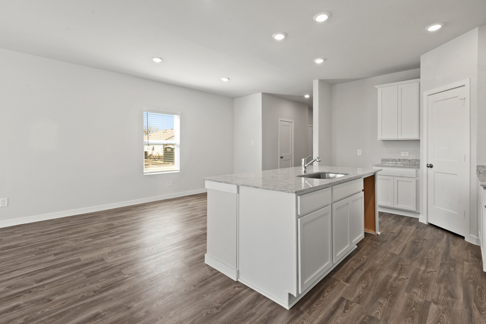 A kitchen with white cabinets.