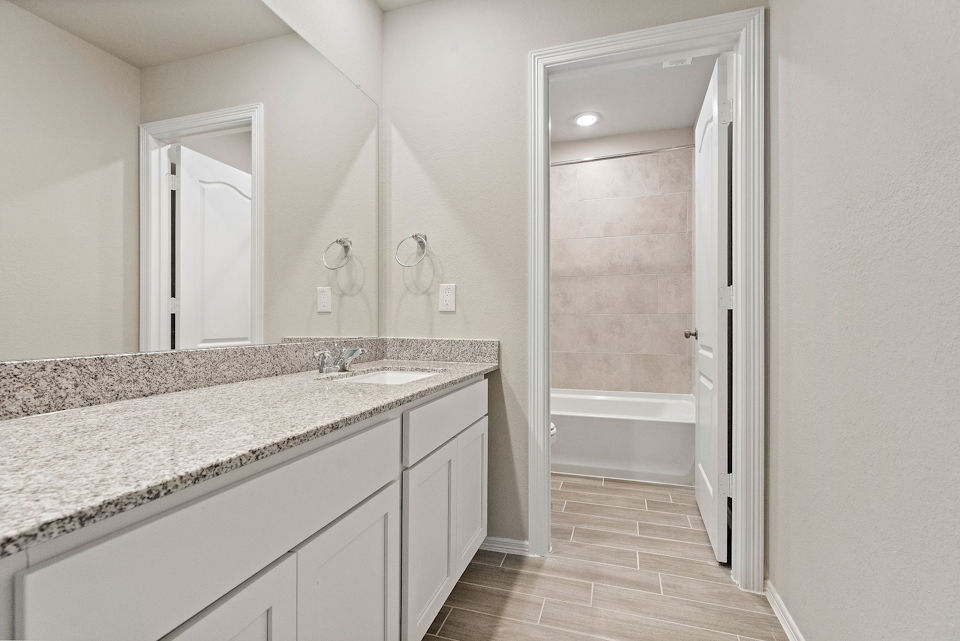A bathroom with a marble countertop.