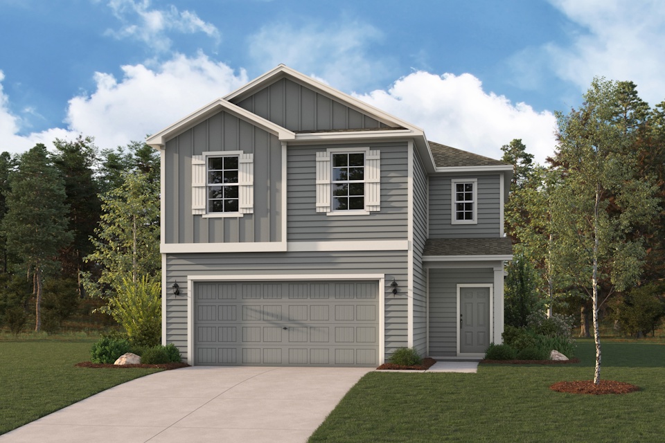A house with a garage and trees.