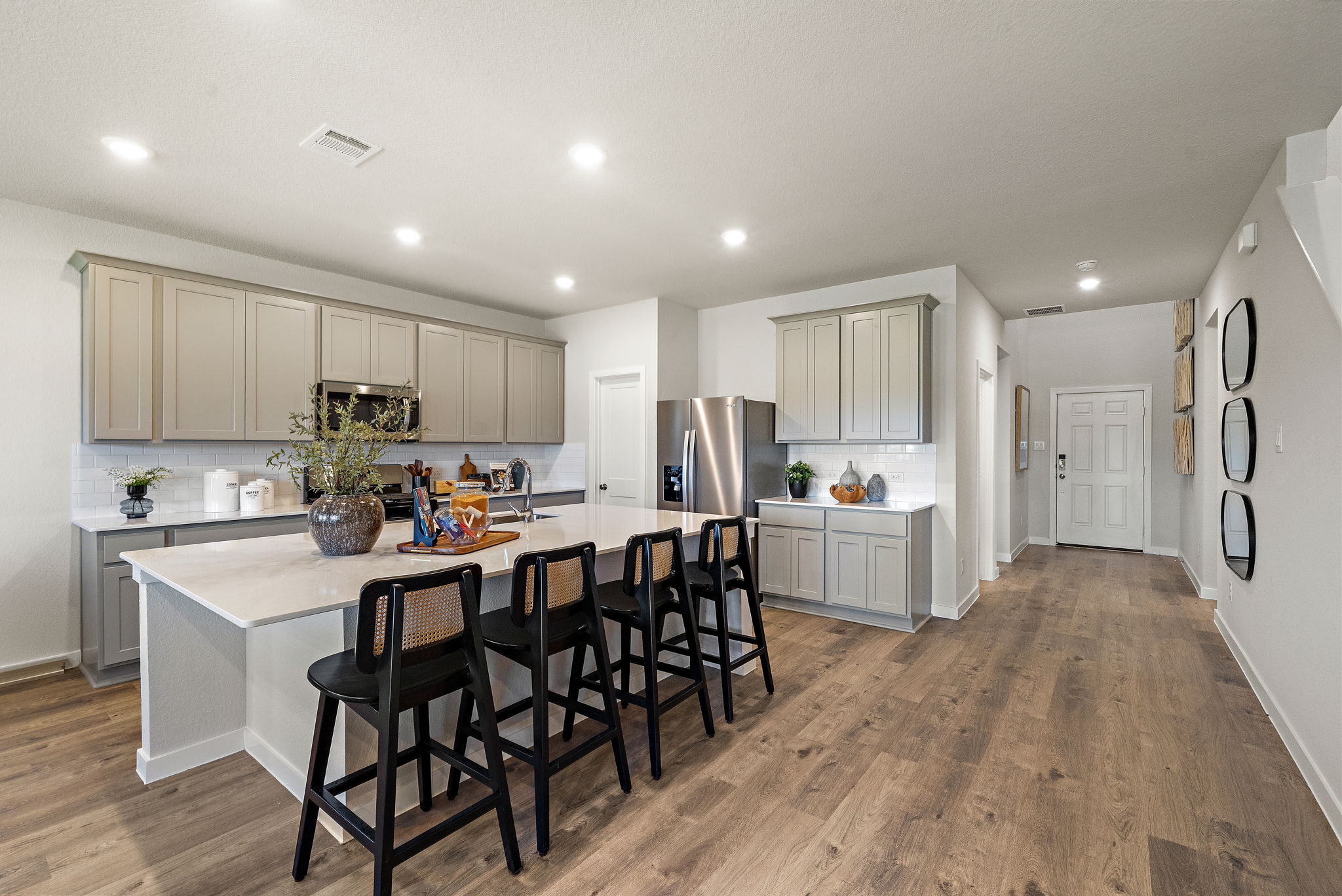 A kitchen with a dining table and chairs.