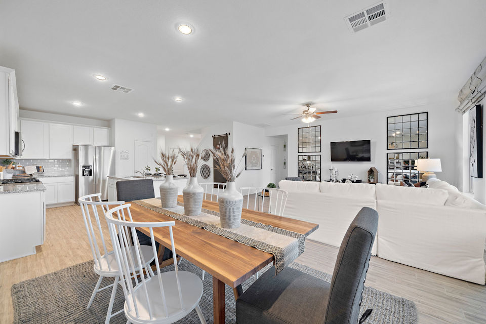 A large living room with a dining table and couches.