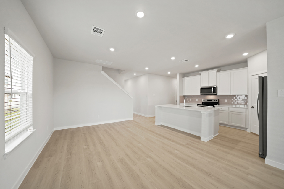 A kitchen with white cabinets.