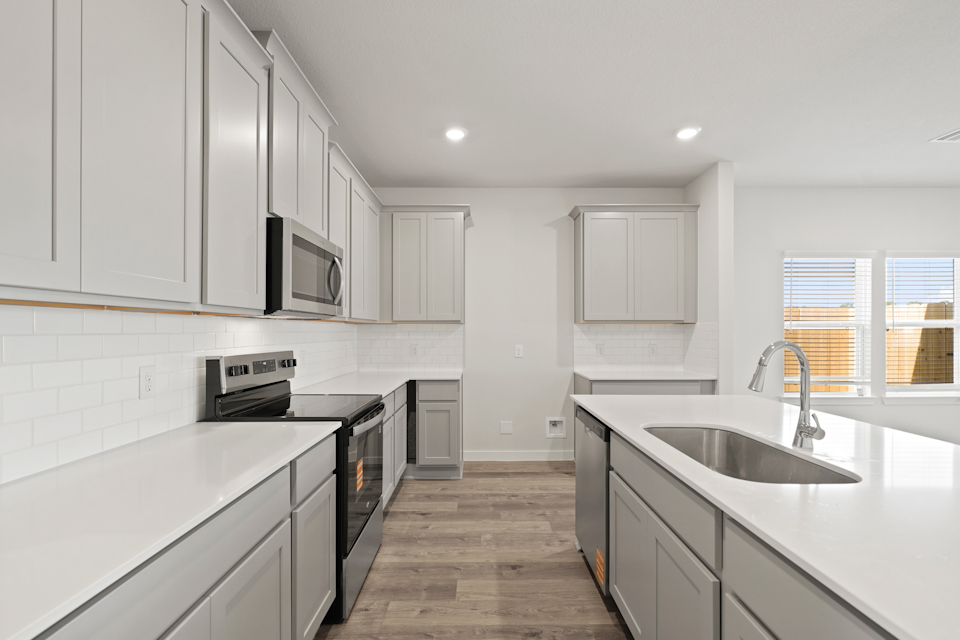A kitchen with white cabinets.