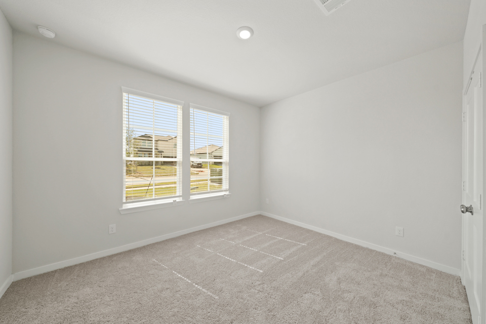 A room with a window and a tile floor.
