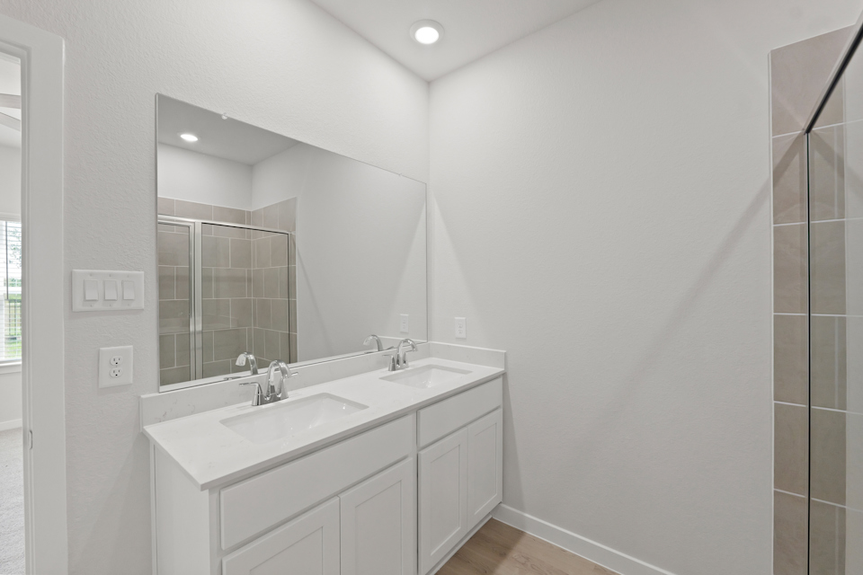 A bathroom with a large mirror.